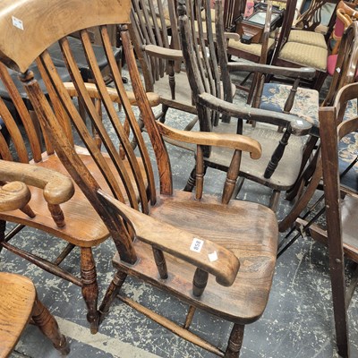 Lot 858 - An antique slat back armchair.