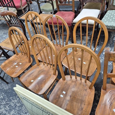 Lot 932 - A set of six Ercol hoop back elm seat chairs.