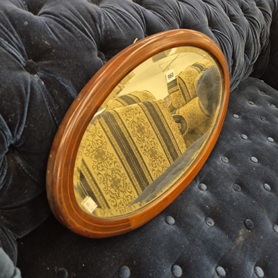 Lot 960 - an Edwardian oval wall mirror.