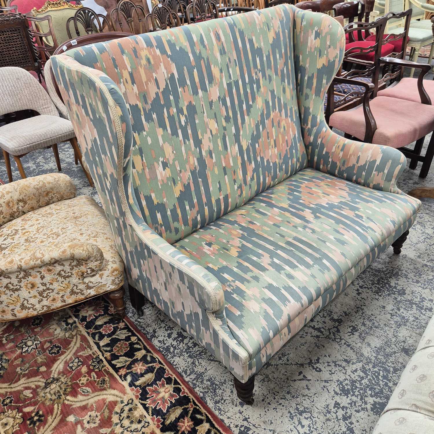 Lot 964 - A small wing back sofa / settee