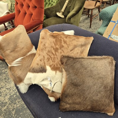 Lot 970 - Four Hide covered cushions.