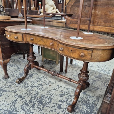 Lot 975 - A Victorian walnut kidney shape writing table...