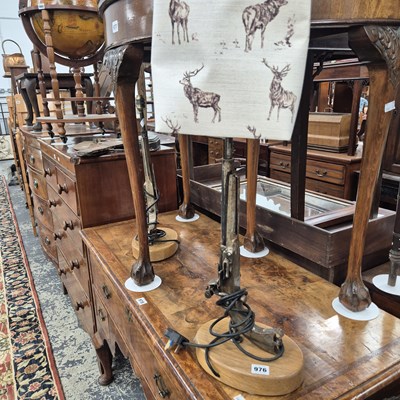 Lot 976 - A pair of wood and iron pistol form table lamps.