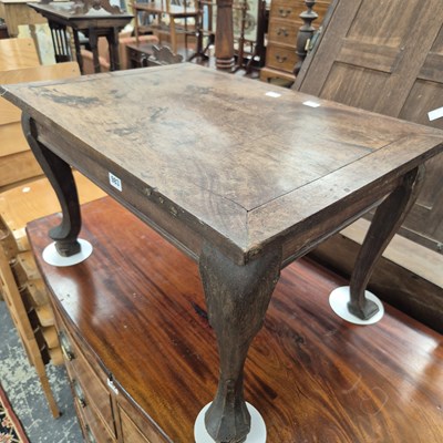 Lot 983 - An oriental hardwood low table on cabriole legs.