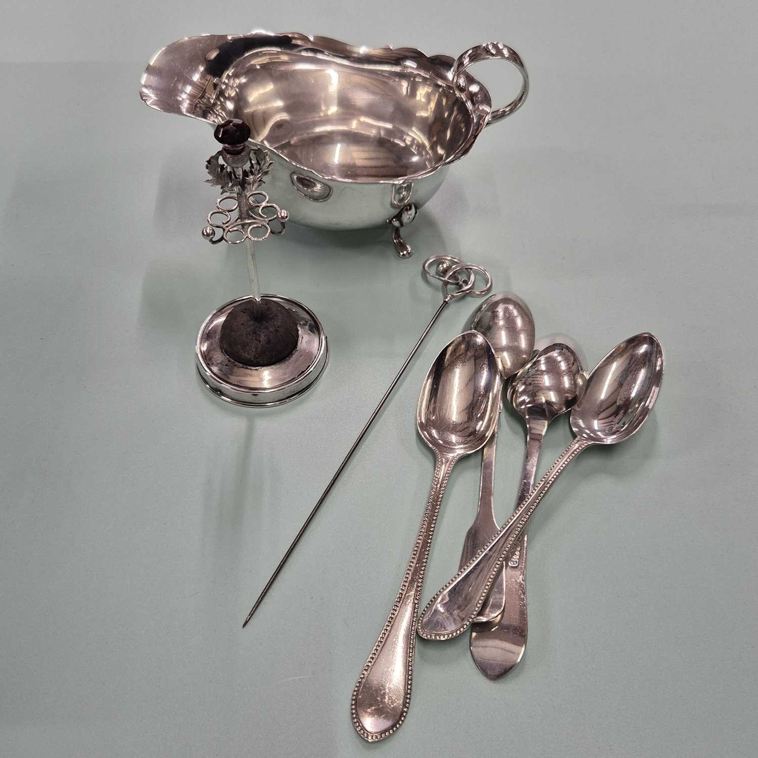 Lot 83 - Hallmarked silver- a sauce boat, four spoons,...