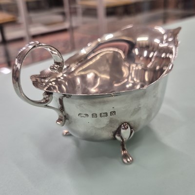 Lot 83 - Hallmarked silver- a sauce boat, four spoons,...