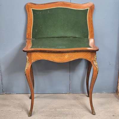 Lot 301 - A floral marquetried kingwood swivel top games...