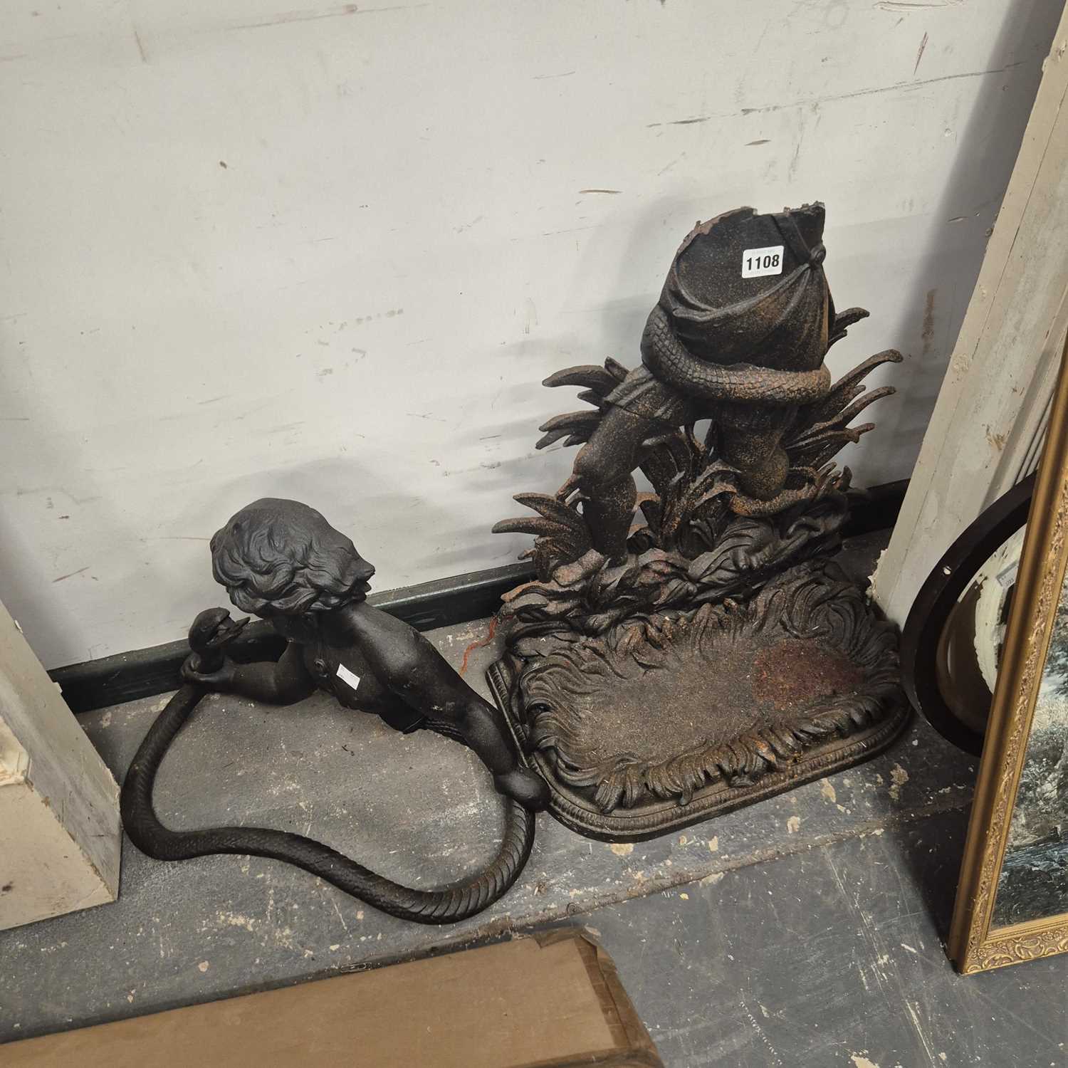Lot 1108 - A cast iron stick stand backed by a child...