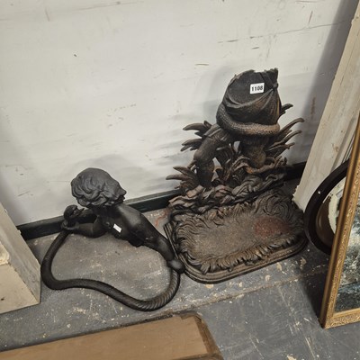 Lot 1108 - A cast iron stick stand backed by a child...
