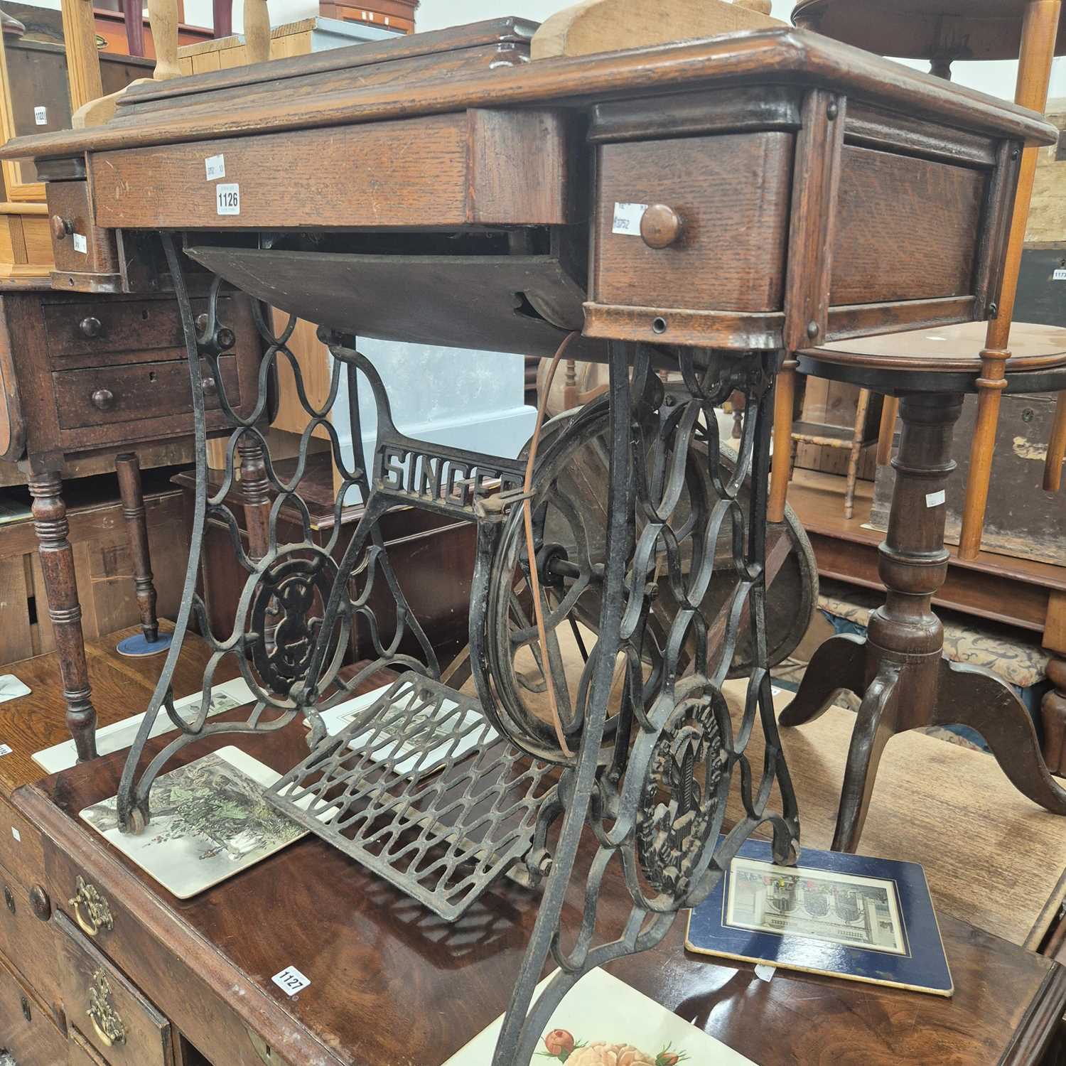 Lot 1126 - A singer sewing machine table with an iron...