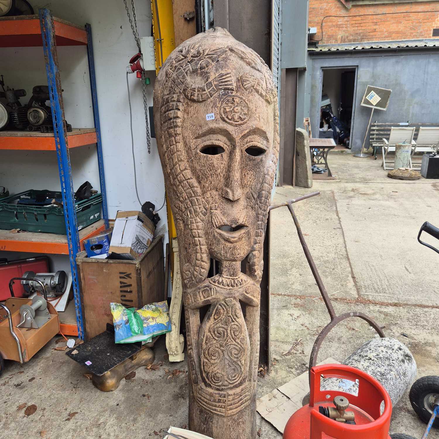 Lot 759 - A large carved palm wood mask form totem