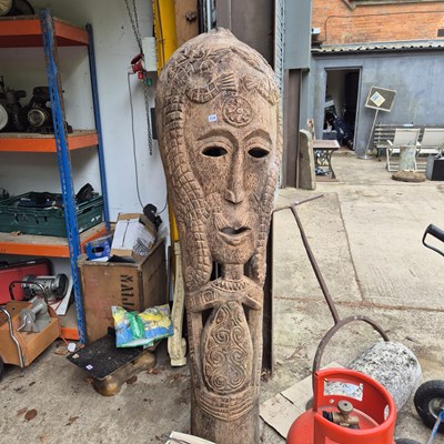 Lot 759 - A large carved palm wood mask form totem