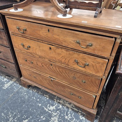 Lot 1009 - A GIII elm chest of four long graduated drawers.