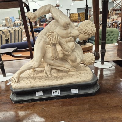 Lot 1018 - A cast sculpture of wrestlers.
