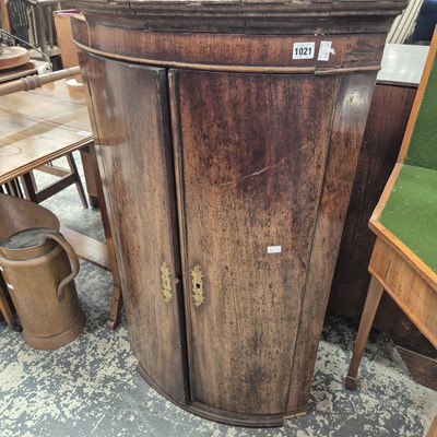 Lot 1021 - A 19th century bow front corner cabinet. Prov....