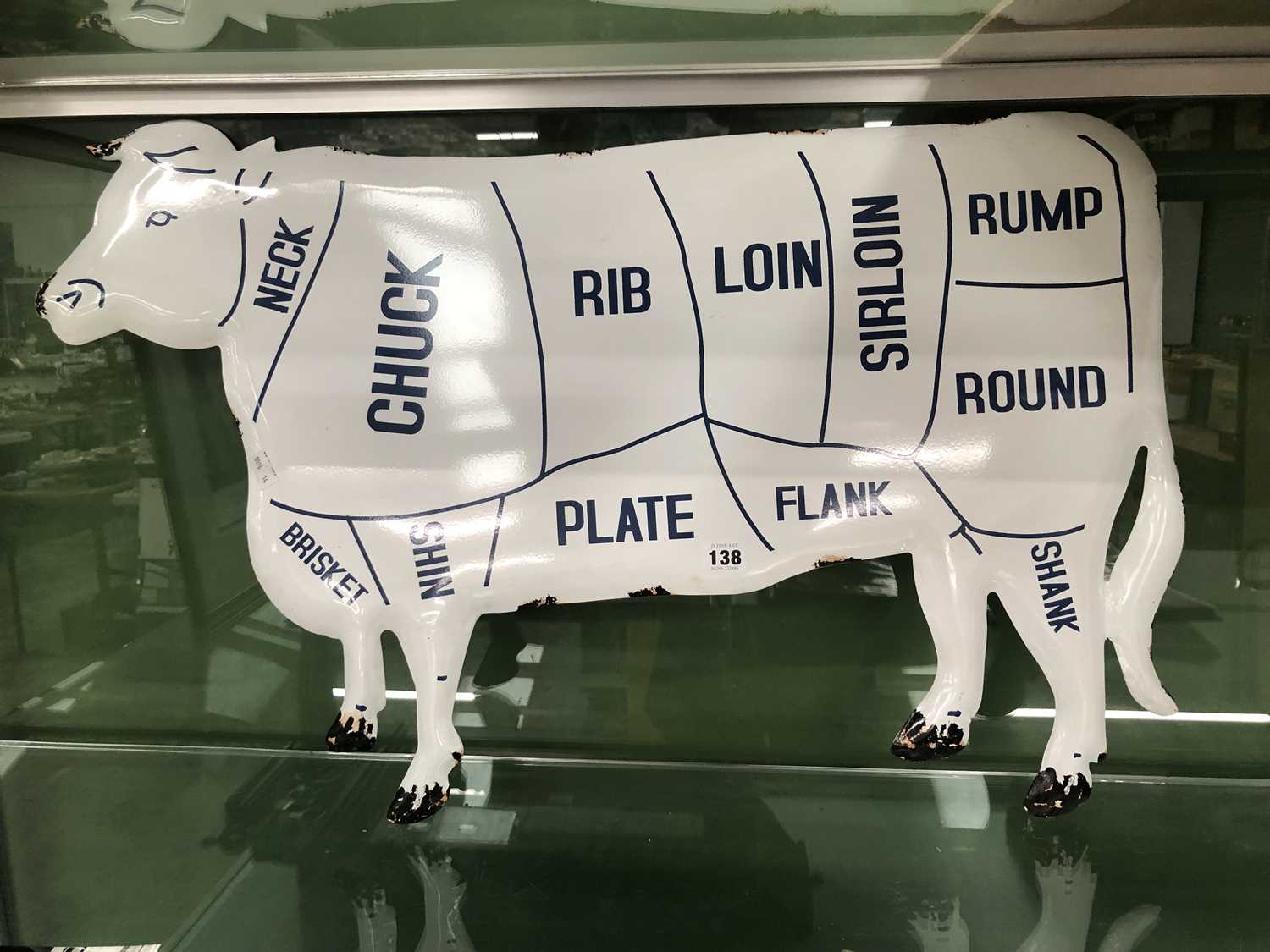 Lot 138 - An enamel butcher's beef cuts cow sign.