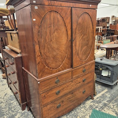 Lot 1027 - An early 19th century mahogany linen press...