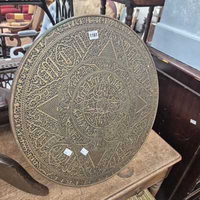 Lot 1161 - A three legged table with an Islamic inscribed...