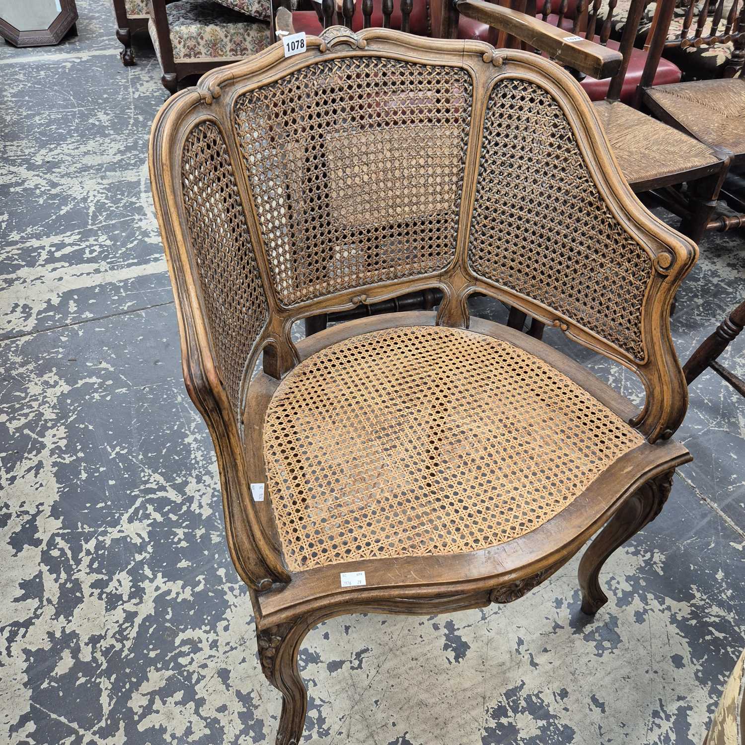Lot 1078 - A French bergere armchair.