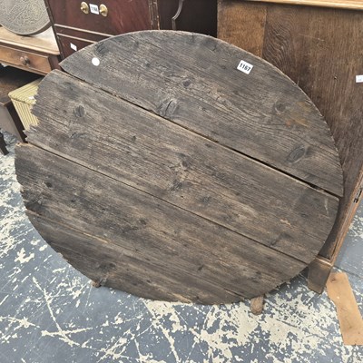 Lot 1167 - A rustic pine circular topped table on a...
