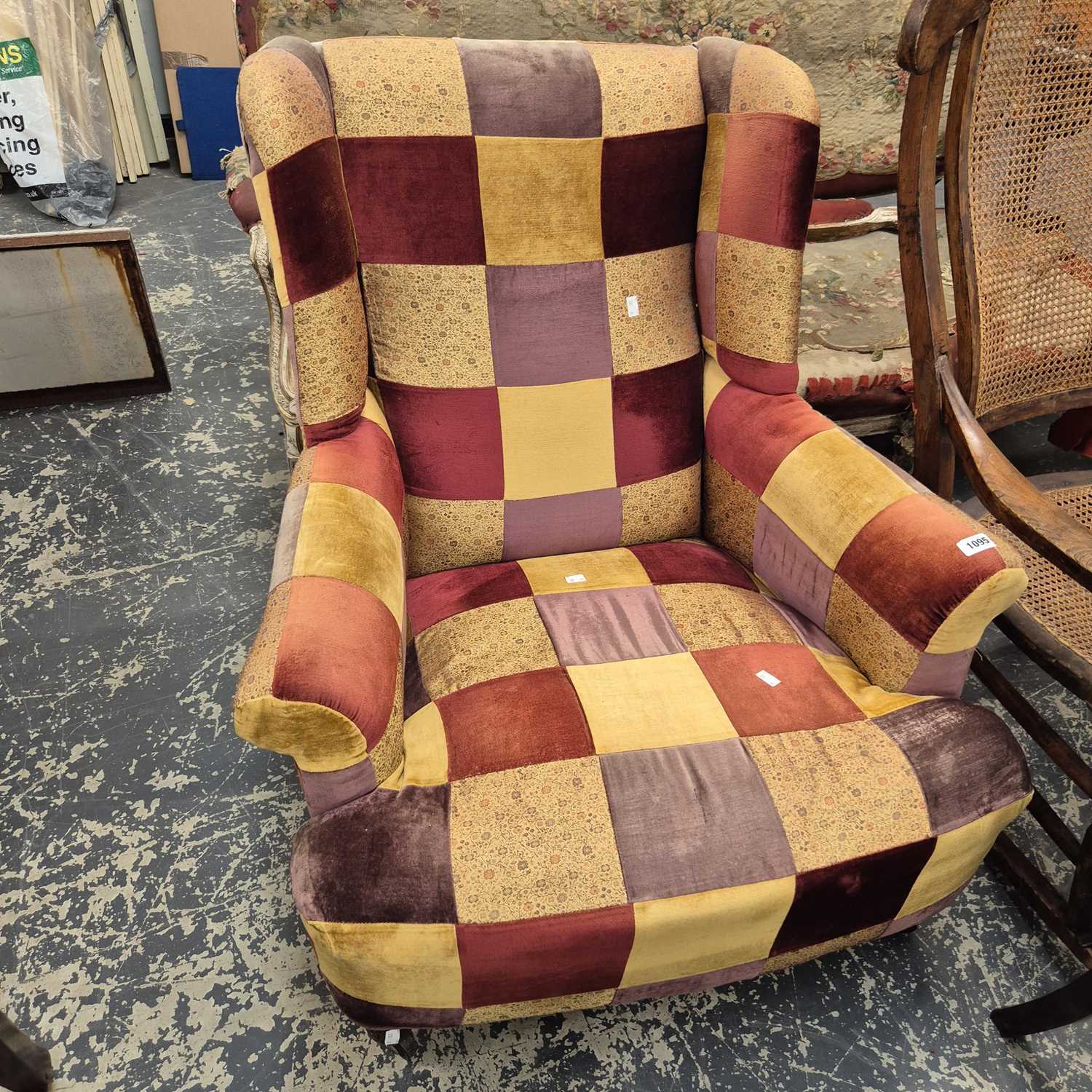 Lot 1095 - A wingback armchair.