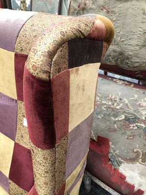 Lot 1095 - A wingback armchair.