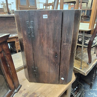 Lot 1195 - A George III oak corner cabinet containing...