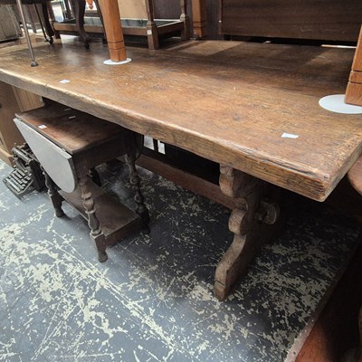 Lot 1199 - A 19th century oak trestle table on shaped...