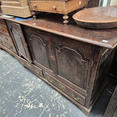 Lot 1215 - An 18th century oak cabinet, the central panel...