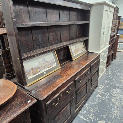 Lot 1216 - An 18th century oak dresser with an enclosed...