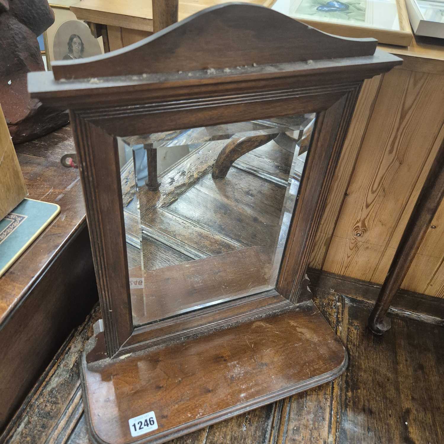 Lot 1246 - A small mahogany hall mirror with shelf.