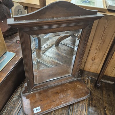 Lot 1246 - A small mahogany hall mirror with shelf.