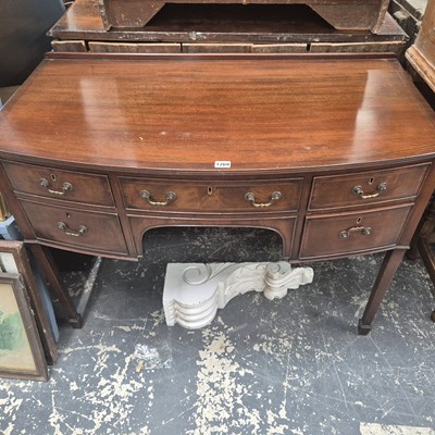 Lot 1269 - A Georgian style bow front dressing table.