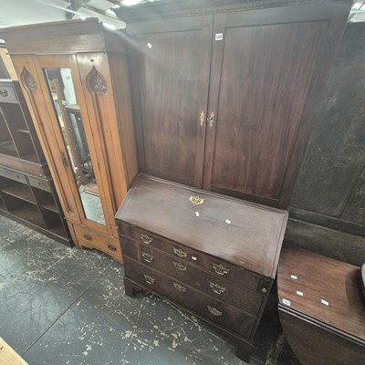 Lot 1355 - A Georgian mahogany bureau-bookcase