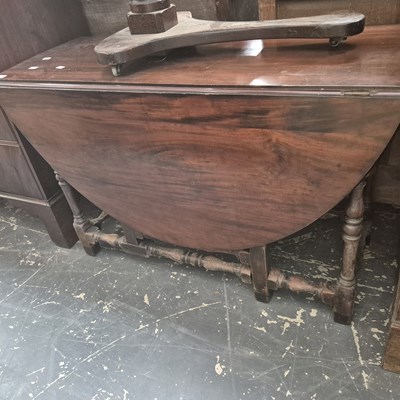 Lot 1357 - An antique mahogany gateleg dining table.