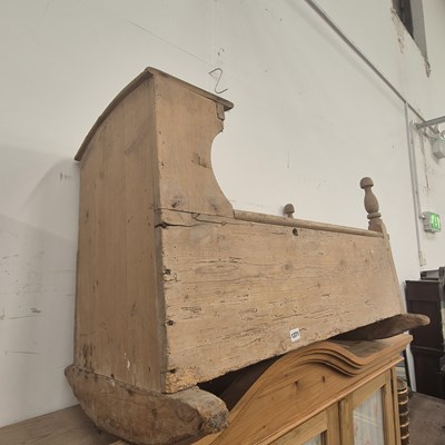 Lot 1371 - An antique pine rocking crib