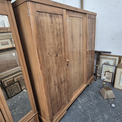 Lot 1451 - A large pine wardrobe. W 178 D 59 H 185 cm