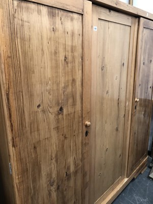 Lot 1451 - A large pine wardrobe. W 178 D 59 H 185 cm