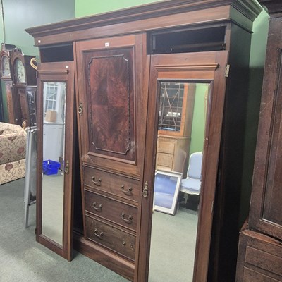 Lot 817 - A large mahogany wardrobe.