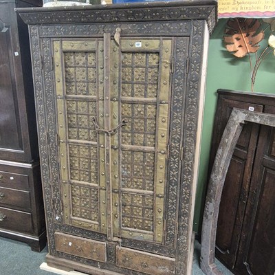 Lot 821 - A large hardwood brass mounted two door...