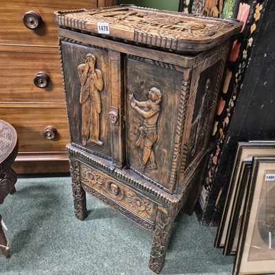 Lot 1478 - A carved hardwood small cabinet