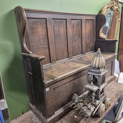 Lot 1483 - An 18th century oak box seat wing back settle....