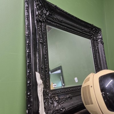 Lot 1506 - A large wall mirror with black frame