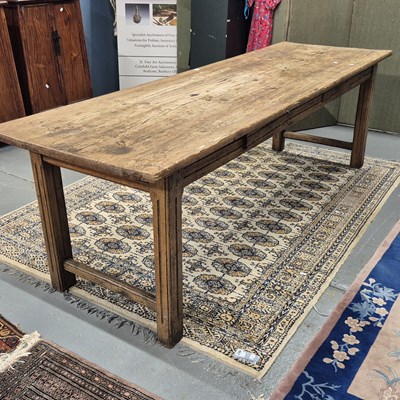 Lot 357 - A pine refectory table on pairs of fluted...