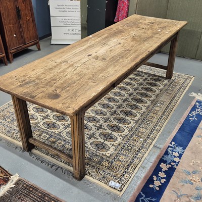 Lot 357 - A pine refectory table on pairs of fluted...