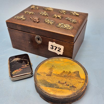 Lot 372 - A papier mache table snuff box bearing a scene...