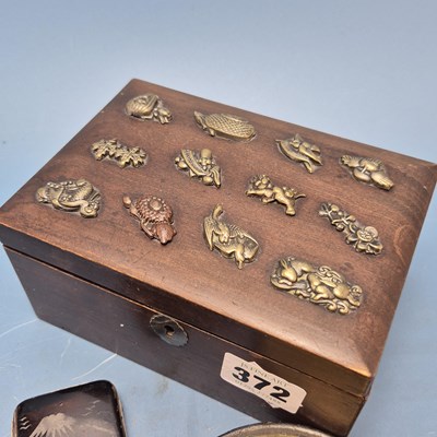 Lot 372 - A papier mache table snuff box bearing a scene...