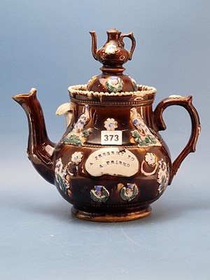 Lot 373 - A  brown ground barge tea pot and cover colour...