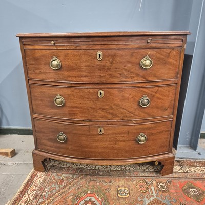 Lot 379 - A 19th century mahogany bow front chest with a...