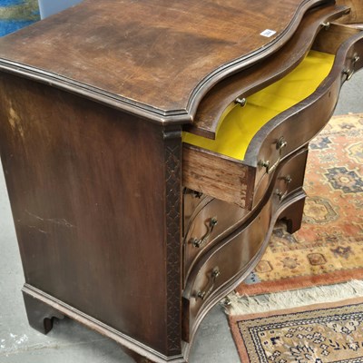 Lot 384 - A George III style mahogany serpentine chest...